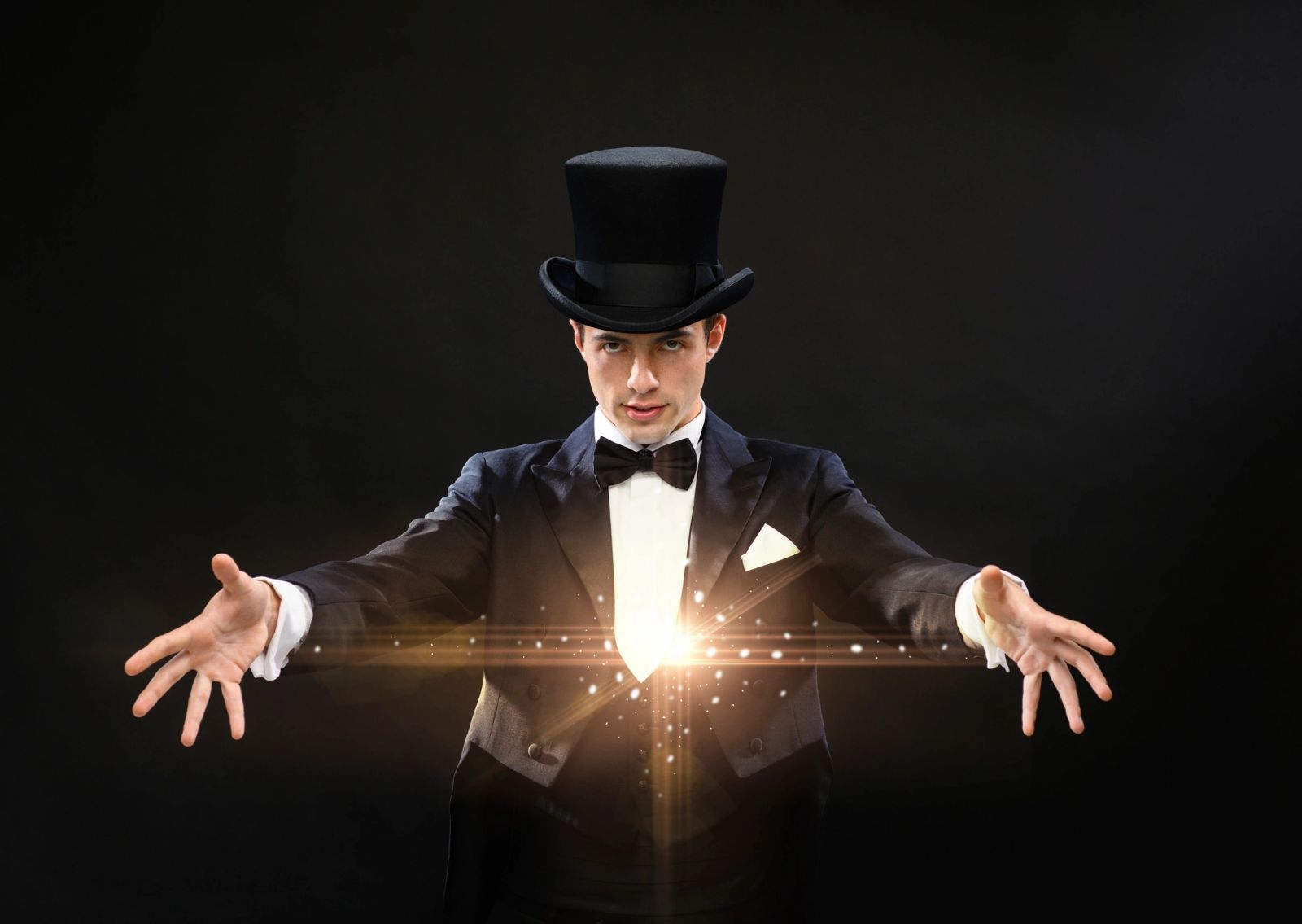 Magician in a top hat performing a dazzling magic trick with glowing light effects.